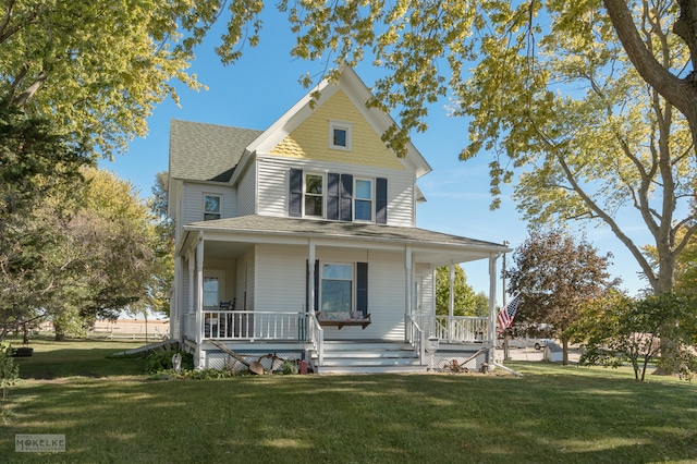 farmhouse featuring a front lawn and a porch