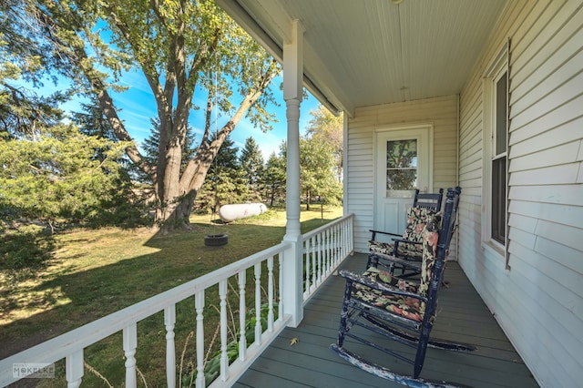 wooden terrace with a lawn