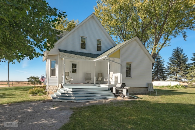 back of property featuring a yard