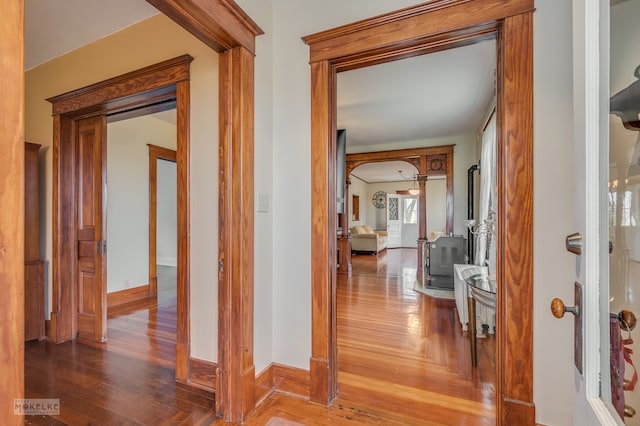 corridor with hardwood / wood-style floors