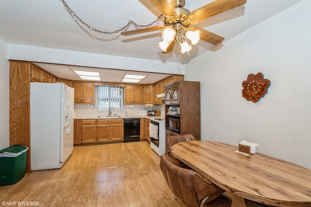 kitchen with white appliances, sink, backsplash, light hardwood / wood-style floors, and ceiling fan