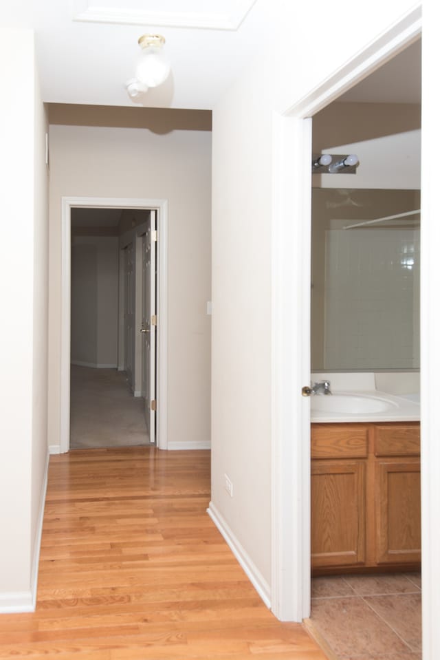 hall featuring light hardwood / wood-style floors and sink