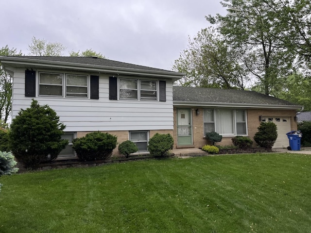 tri-level home featuring a garage and a front lawn