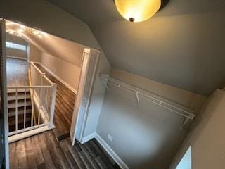 bonus room with lofted ceiling and dark hardwood / wood-style floors