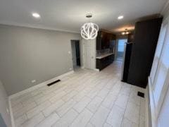 unfurnished dining area featuring crown molding