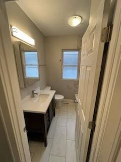 bathroom with tile patterned floors, vanity, and toilet