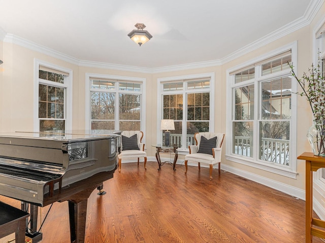 living area with ornamental molding and hardwood / wood-style floors