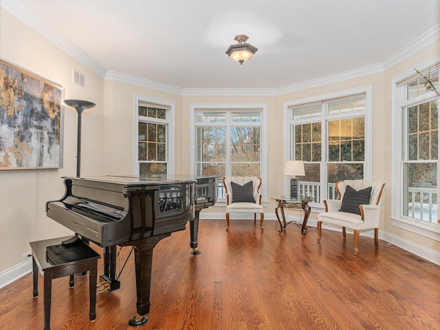 living area with wood-type flooring and crown molding