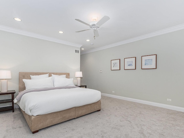 carpeted bedroom with ornamental molding and ceiling fan