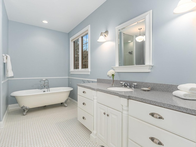 bathroom with vanity and a washtub