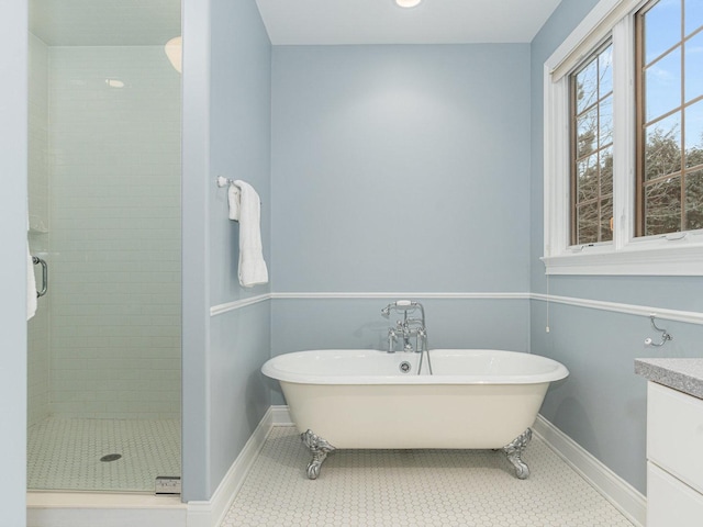 bathroom with tile patterned floors, vanity, and independent shower and bath