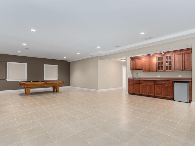 interior space featuring light tile patterned flooring, sink, and stainless steel dishwasher