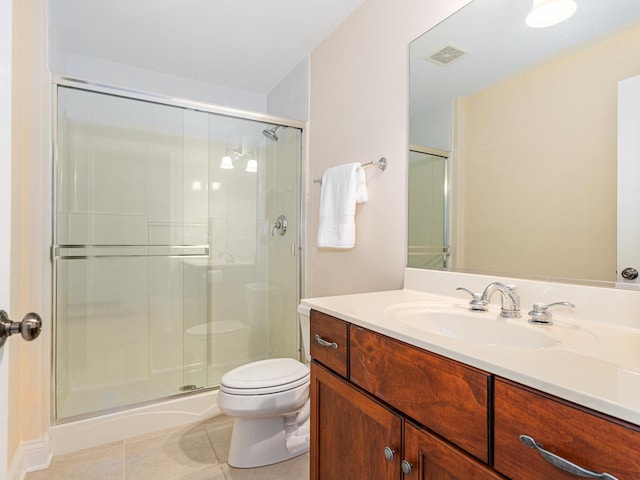 bathroom featuring vanity, toilet, a shower with shower door, and tile patterned flooring