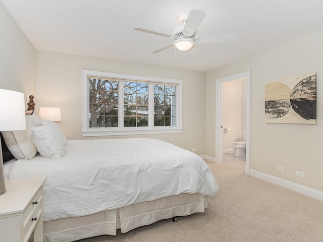 bedroom featuring light carpet, connected bathroom, and ceiling fan