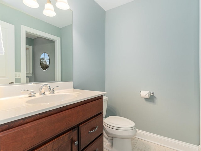 bathroom with vanity, tile patterned floors, and toilet