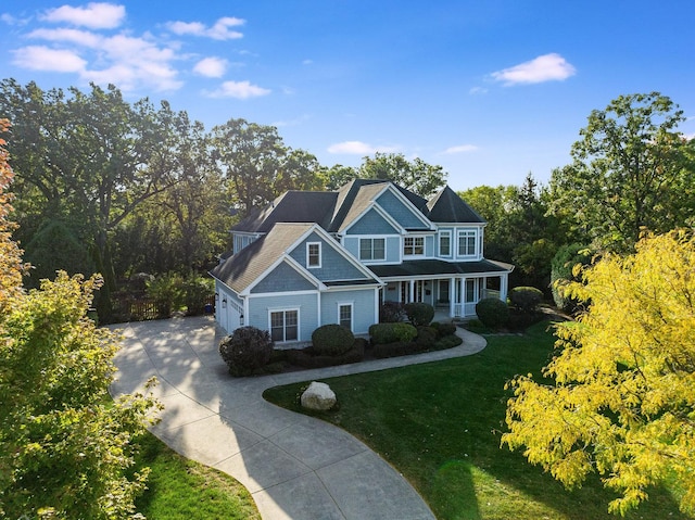 craftsman house featuring a garage and a front yard