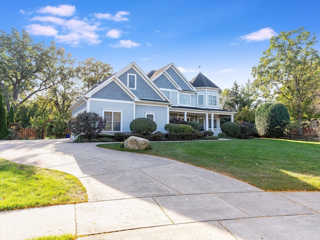 view of front facade with a porch and a front lawn