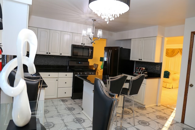 kitchen featuring white cabinets, decorative backsplash, black appliances, and a notable chandelier