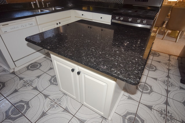 details featuring white dishwasher, white cabinets, sink, and stainless steel range with gas cooktop