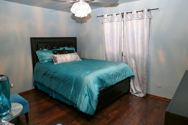 bedroom with dark wood-type flooring and ceiling fan