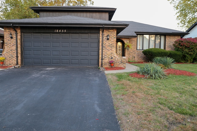 view of front of property with a garage and a front yard