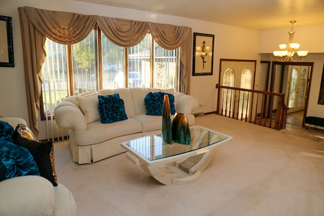 living room featuring a chandelier and carpet