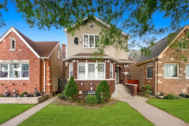 traditional-style home with brick siding and a front yard