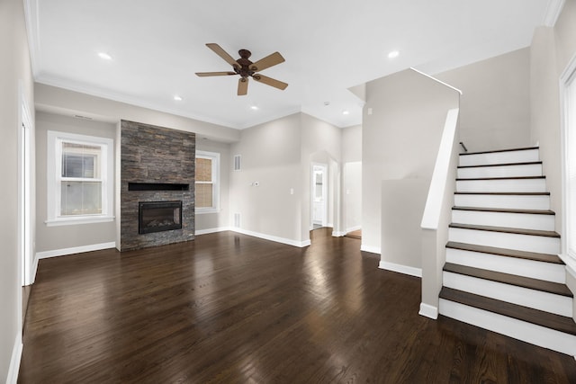 unfurnished living room with ceiling fan, ornamental molding, dark hardwood / wood-style flooring, and a fireplace