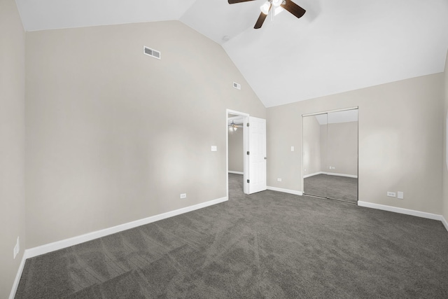 empty room featuring dark colored carpet, high vaulted ceiling, and ceiling fan