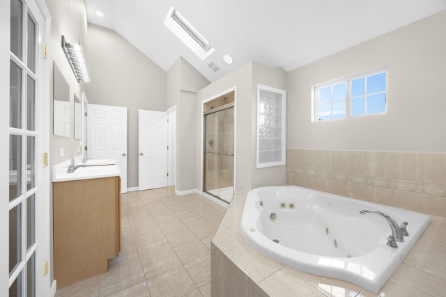 bathroom with vaulted ceiling with skylight, vanity, separate shower and tub, and tile patterned flooring