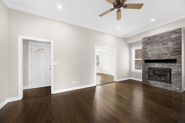 unfurnished living room featuring crown molding, dark hardwood / wood-style floors, a fireplace, and ceiling fan