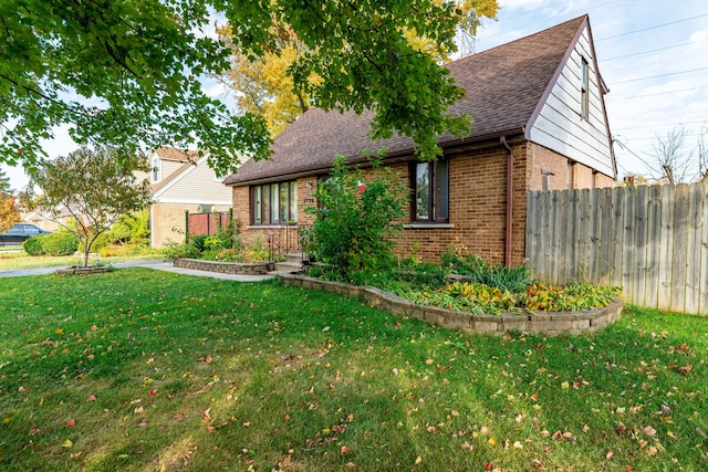 view of side of property with a lawn