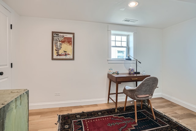 home office with wood-type flooring