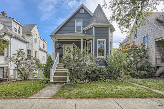 view of front of property featuring covered porch and a front lawn