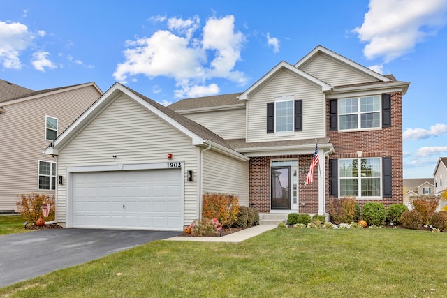 view of front of home featuring a garage and a front lawn