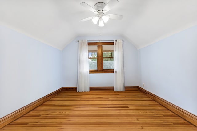 additional living space with light hardwood / wood-style floors, vaulted ceiling, and ceiling fan