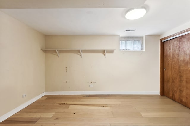 laundry room featuring light wood-type flooring