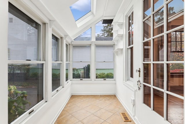 unfurnished sunroom featuring a skylight