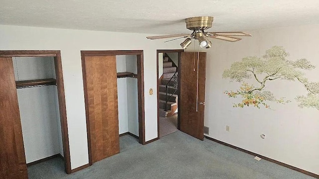 unfurnished bedroom with ceiling fan, a textured ceiling, and dark carpet