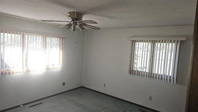 empty room featuring a textured ceiling and ceiling fan