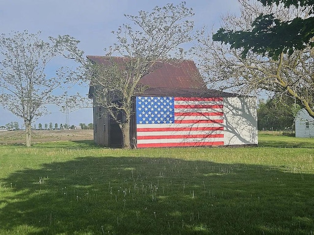 view of outbuilding featuring a yard