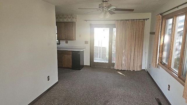 interior space with dark colored carpet and ceiling fan