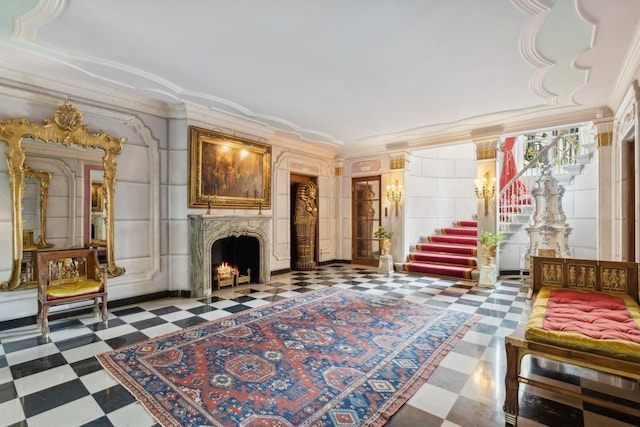 1355 N Astor St, Chicago, IL 60610 - living area with tile patterned floors, a fireplace, ornamental molding, and stairs
