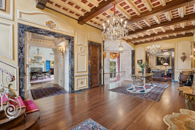 1355 N Astor St, Chicago, IL 60610 - living area with a notable chandelier, decorative columns, a decorative wall, wood finished floors, and beamed ceiling