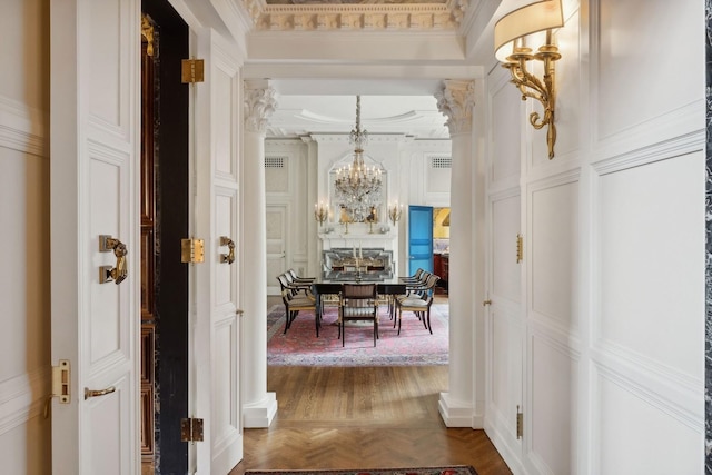 1355 N Astor St, Chicago, IL 60610 - hallway featuring crown molding, a chandelier, and a decorative wall