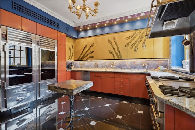 1355 N Astor St, Chicago, IL 60610 - kitchen with under cabinet range hood, a sink, a chandelier, backsplash, and appliances with stainless steel finishes