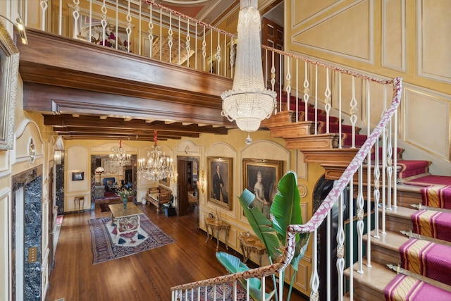 1355 N Astor St, Chicago, IL 60610 - stairs with a premium fireplace, a decorative wall, a chandelier, wood finished floors, and beam ceiling