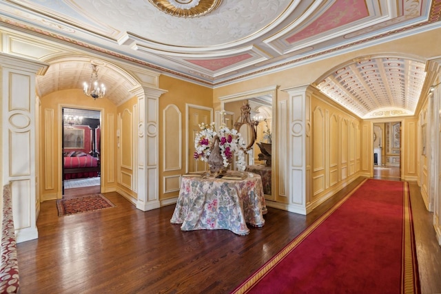 1355 N Astor St, Chicago, IL 60610 - hall with a decorative wall, decorative columns, dark wood finished floors, arched walkways, and a notable chandelier