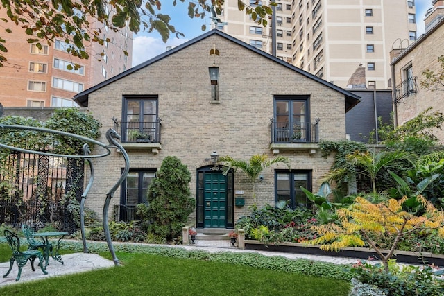 1355 N Astor St, Chicago, IL 60610 - back of property with brick siding, a lawn, and a balcony
