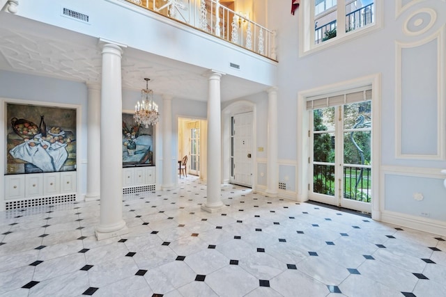 1355 N Astor St, Chicago, IL 60610 - foyer featuring a chandelier, visible vents, a towering ceiling, and ornate columns